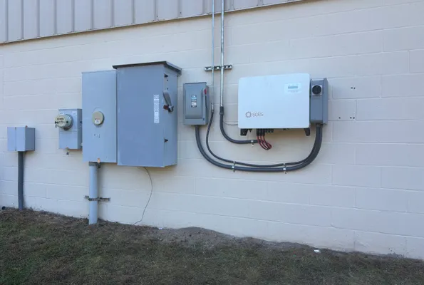 Solar inverter and disconnects on a block wall in North Georgia by Innovative Electrical Systems